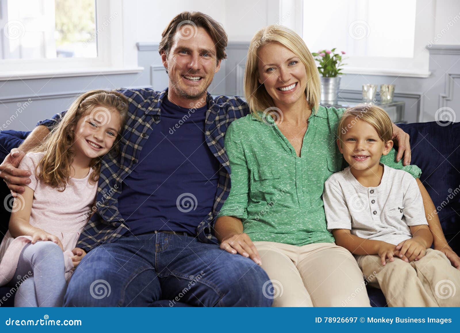Portrait of Family Sitting on Sofa Together Stock Image Image of