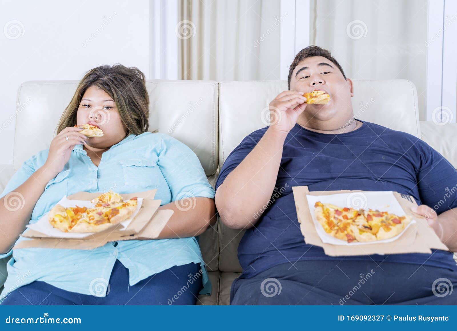 Fat Asian Couple Eating Pizza While Watching Tv Stock Image Image Of