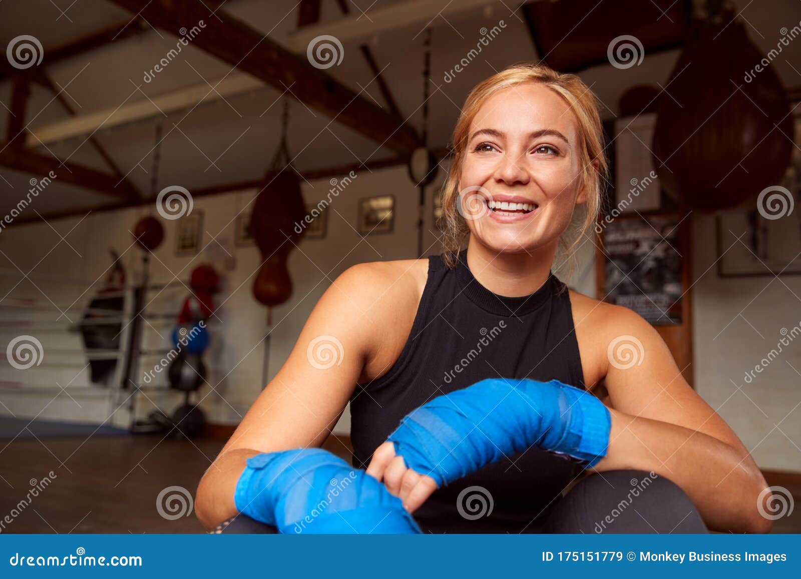 Portrait of Female Boxer with Protective Wraps on Hands Training in Gym