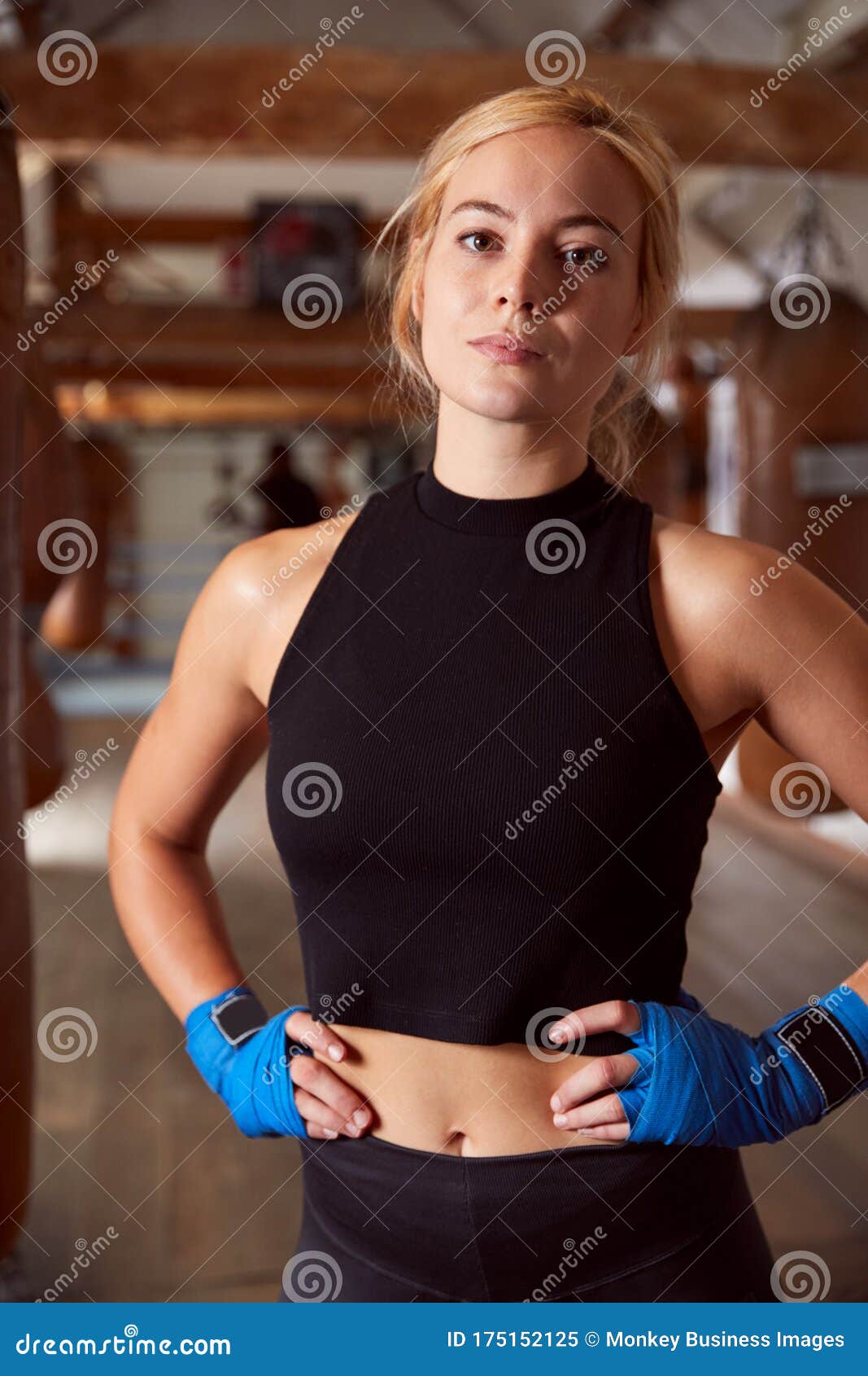 Portrait of Female Boxer with Protective Wraps on Hands Training in Gym