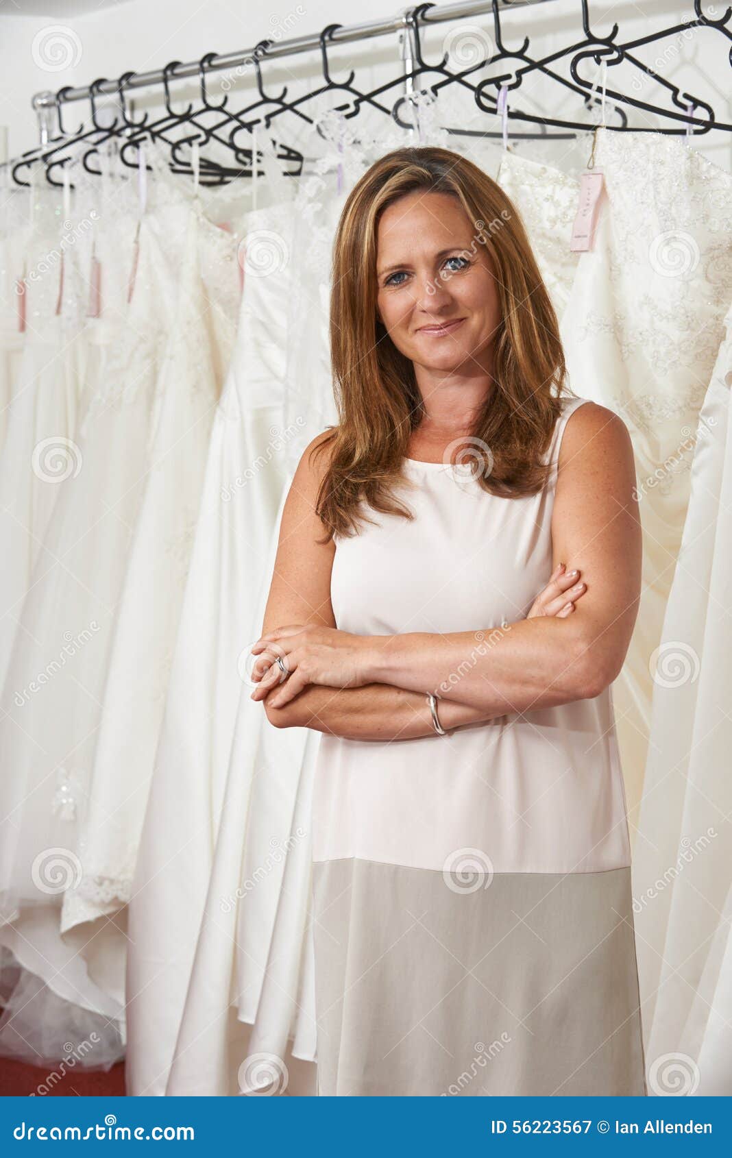 Portrait Of Female Bridal  Store  Owner  With Wedding  Dresses  