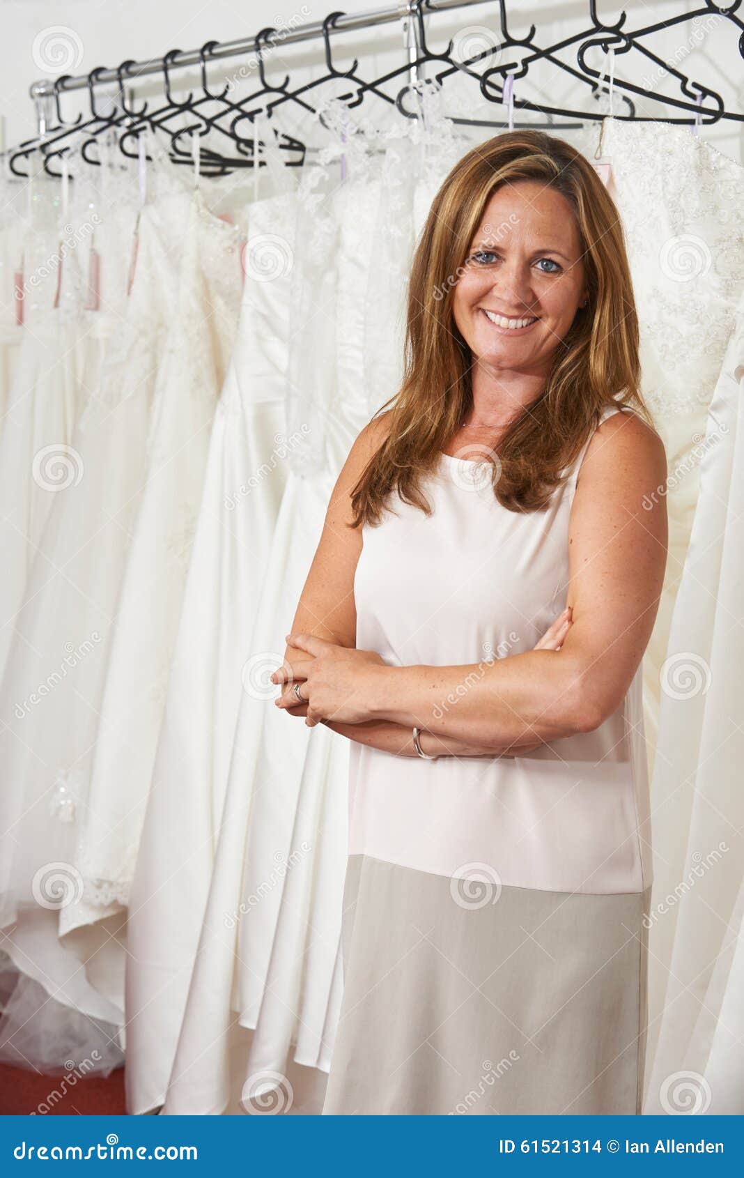 Portrait Of Female Bridal  Store  Owner  With Wedding  Dresses  