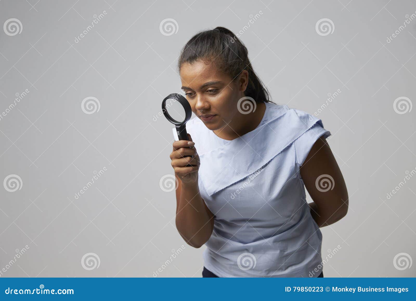 portrait of female criminologist with magnifying glass