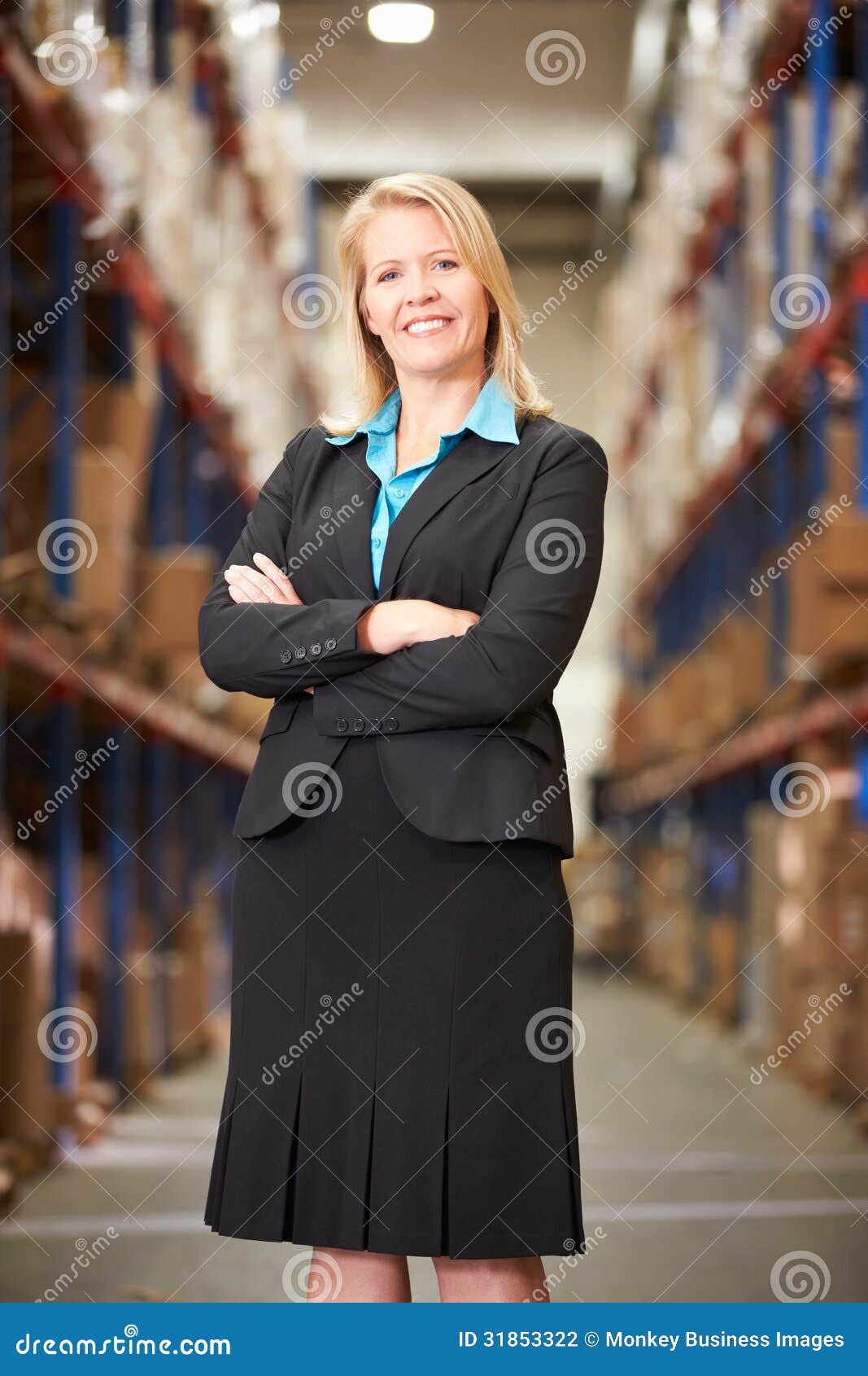 Portrait Of Female Manager In Warehouse looking to camera