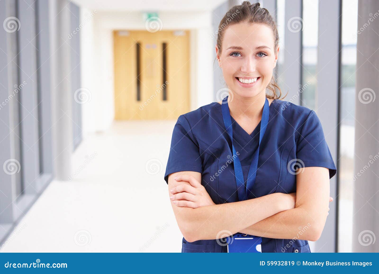 portrait of female nurse standing in hospital corridor