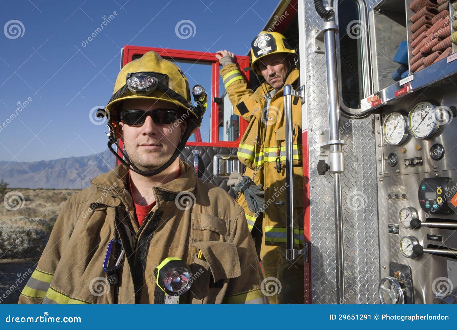 portrait of a fireman with coworker in the background