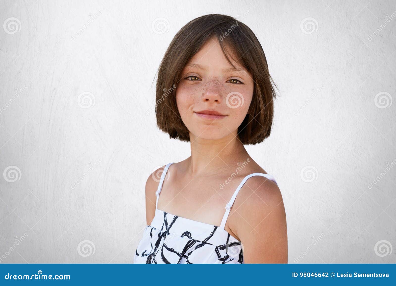 Portrait Of Freckled Little Girl With Dark Short Hair Hazel
