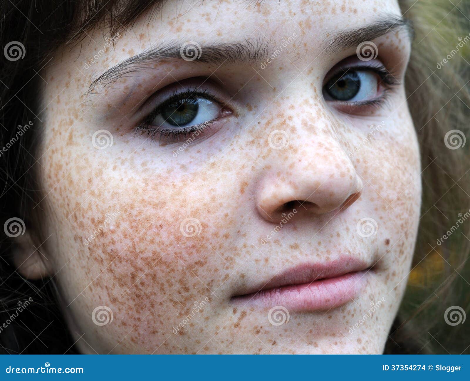 Portrait of a beautiful girl with freckles, close-up 