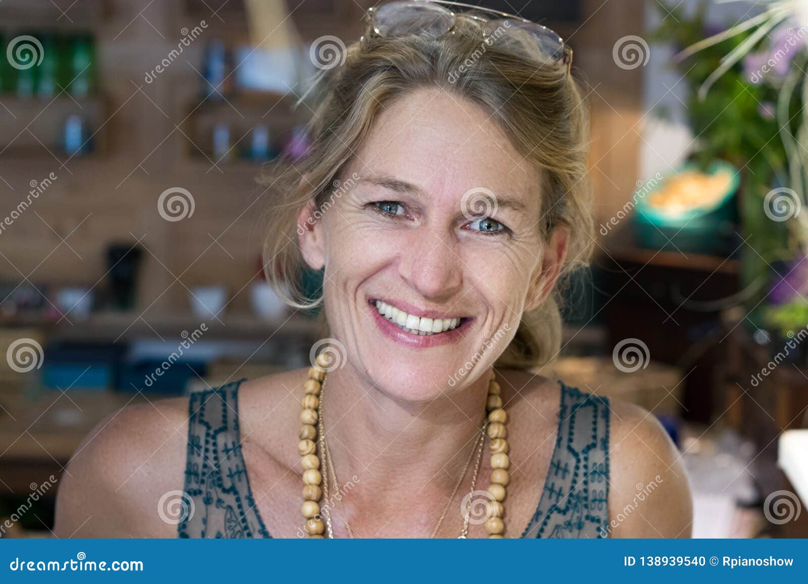Portrait Of A French Blonde Mature Woman Smiling At Her Store