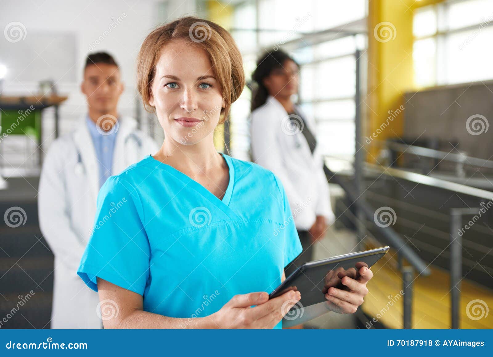 Portrait Of A Friendly Caucasian Female Doctor And Team In Bright