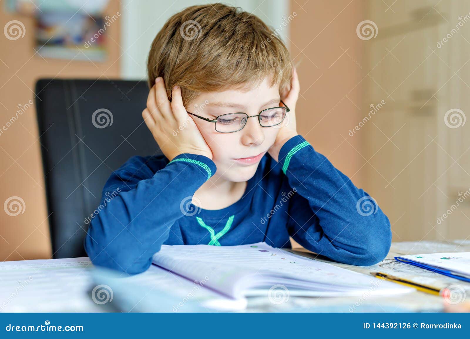 little boy crying doing homework