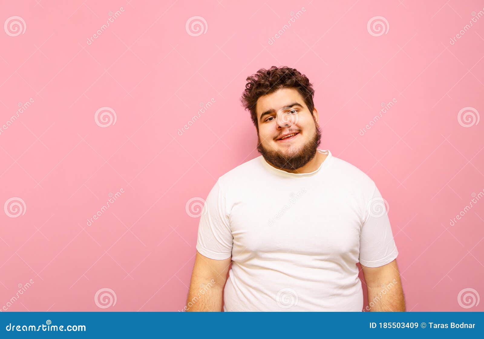 Portrait of a Funny Overweight Guy on a Pink Background, Wearing a White  T-shirt and Beard, Looking into the Camera and Smiling. Stock Image - Image  of copy, masculine: 185503409