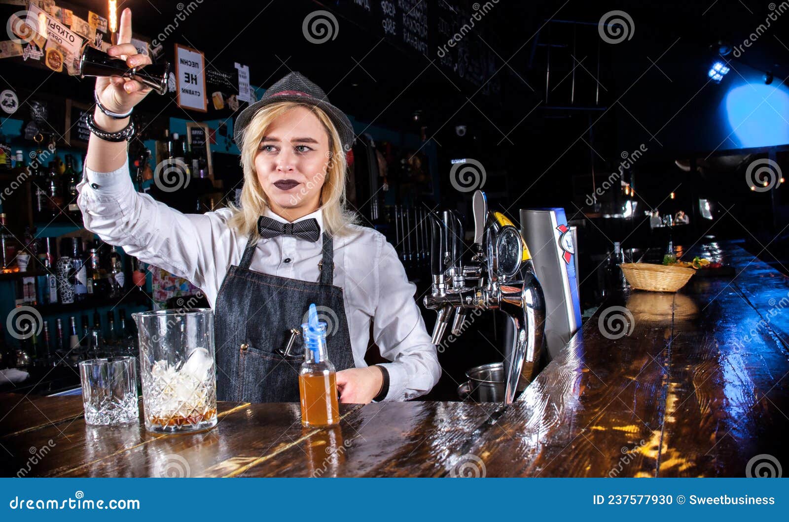 Charming Woman Barkeeper is Pouring a Drink Behind the Bar Stock Photo ...