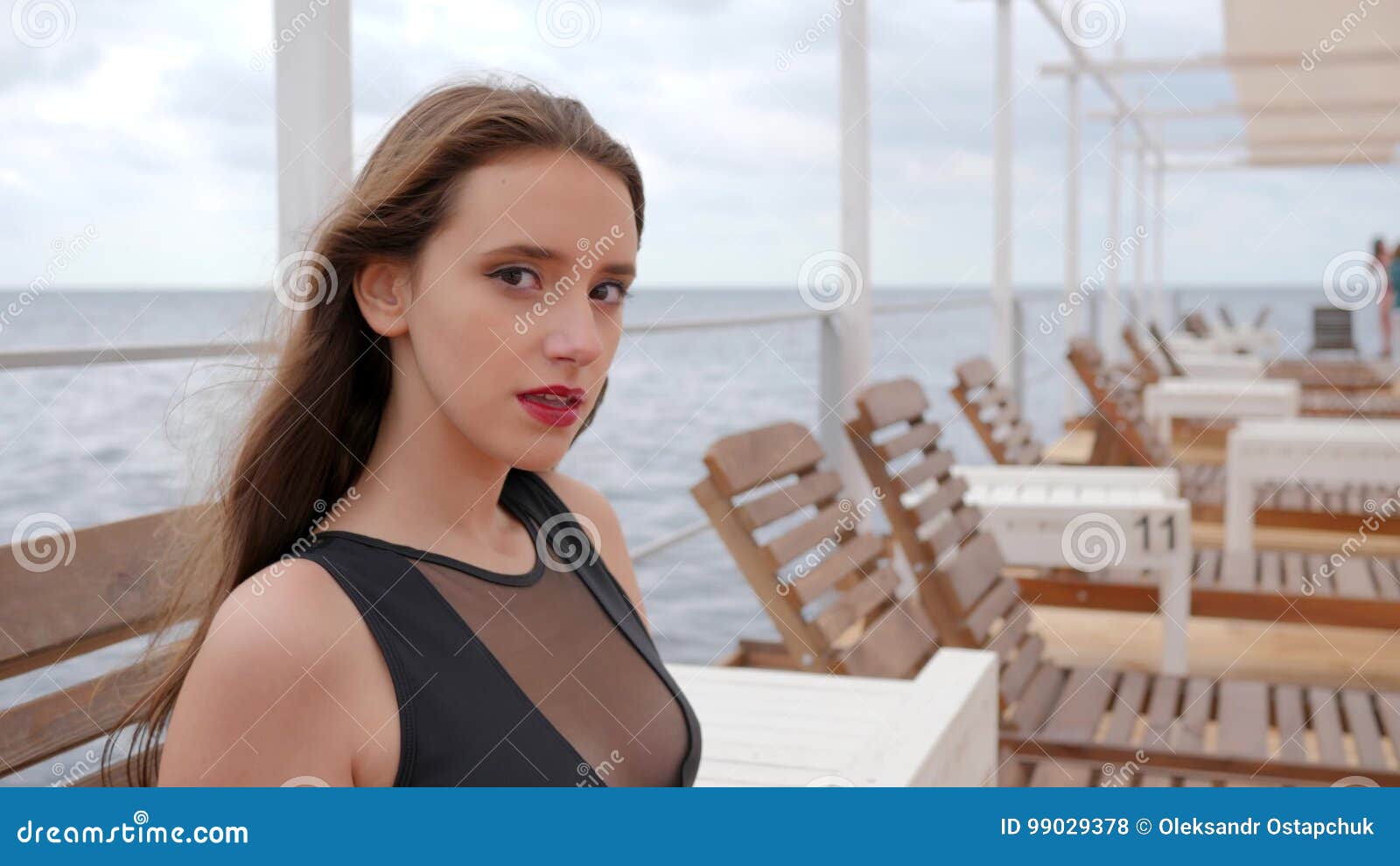 Portrait Girl In Bathing Suit Sitting On Sun Lounger On Seafront Young Woman In Swimsuit Sit 