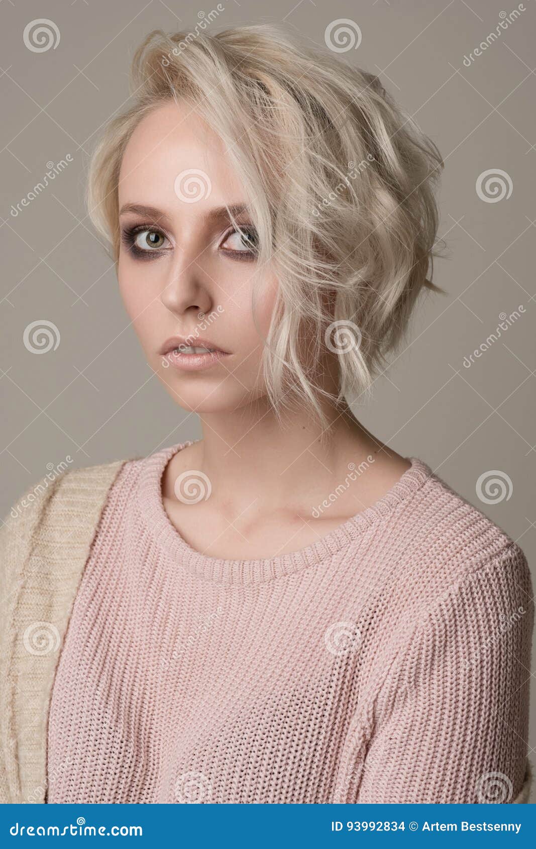 Portrait of Girl of Blonde with Dark Eye Makeup and Short Hair, Thrown on One Side, Light Pink Sweater on a Light Background Stock Photo - Image of light, glamour: 93992834 Portrait of Girl of Blonde with Dark Eye Makeup and Short Hair, Thrown on One Side, Light Pink Sweater on a Light Background Stock Photo - Image of light, glamour: 93992834