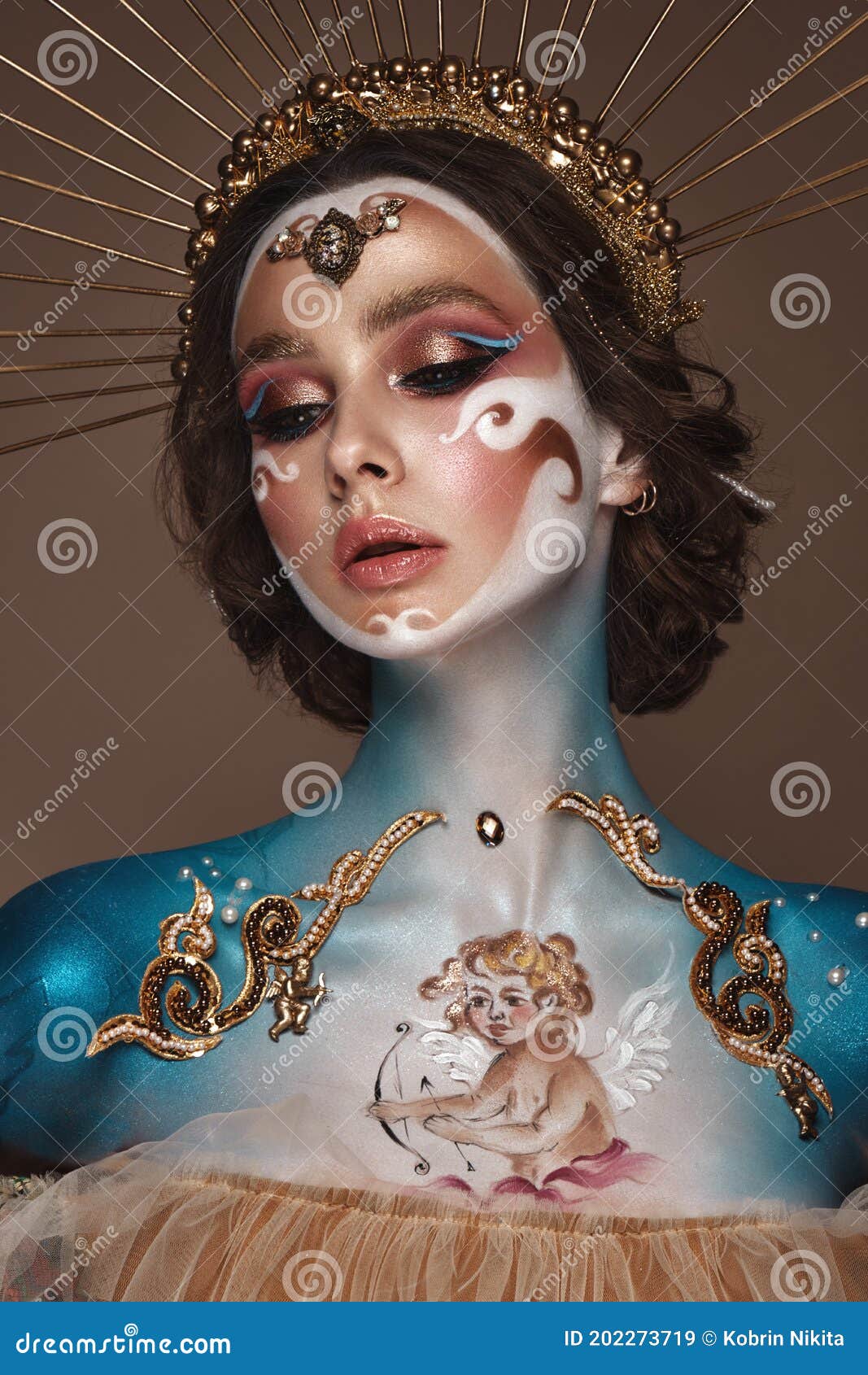 portrait of a girl with gold and blue creative art make-up.