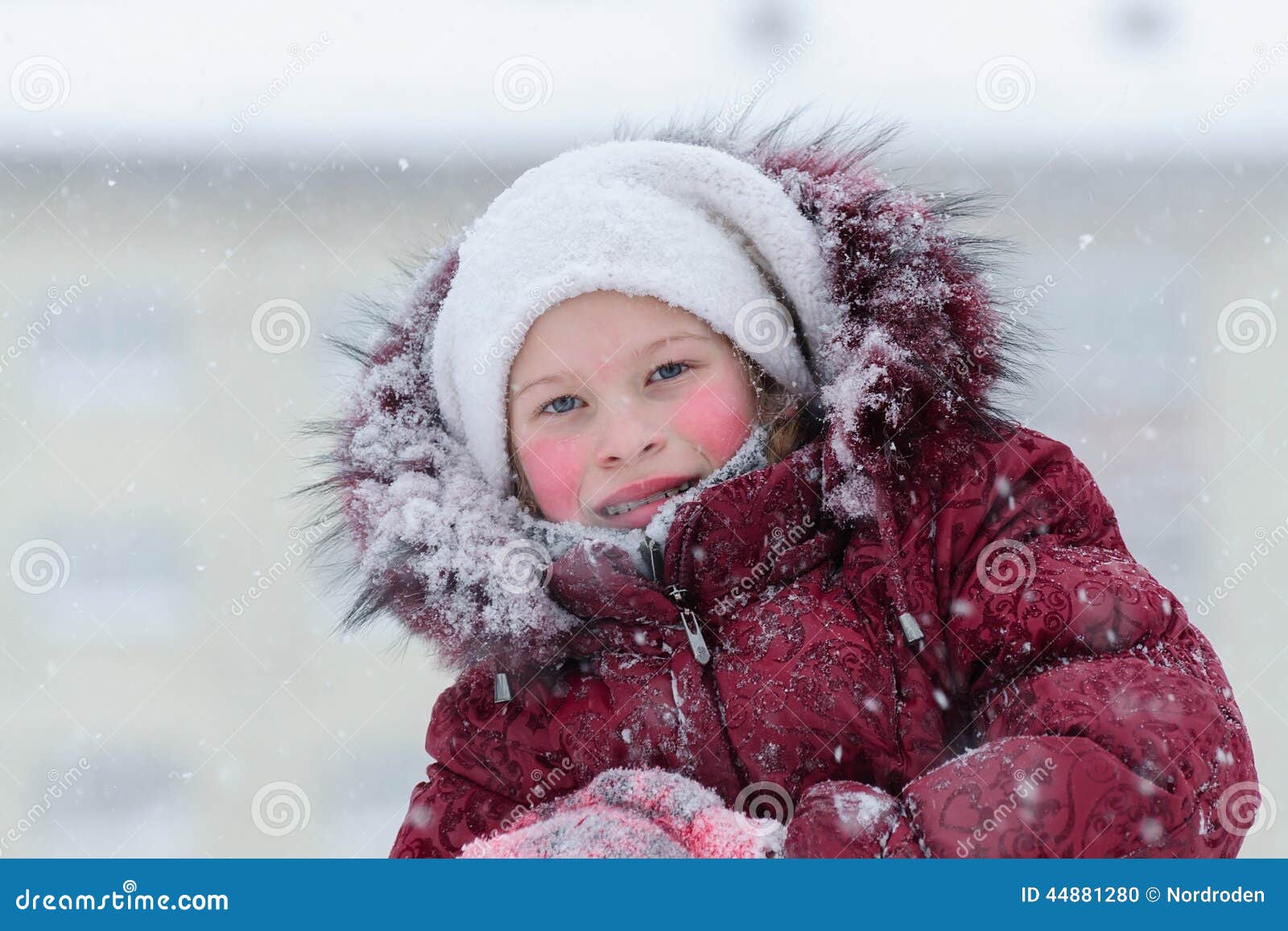 Portrait of a Girl in a Red Down Jacket. Stock Photo Image of
