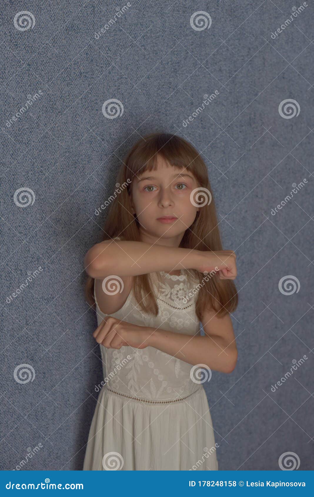 Portrait. Girl 9 Years Old on a Background of Blue Wallpaper at Home