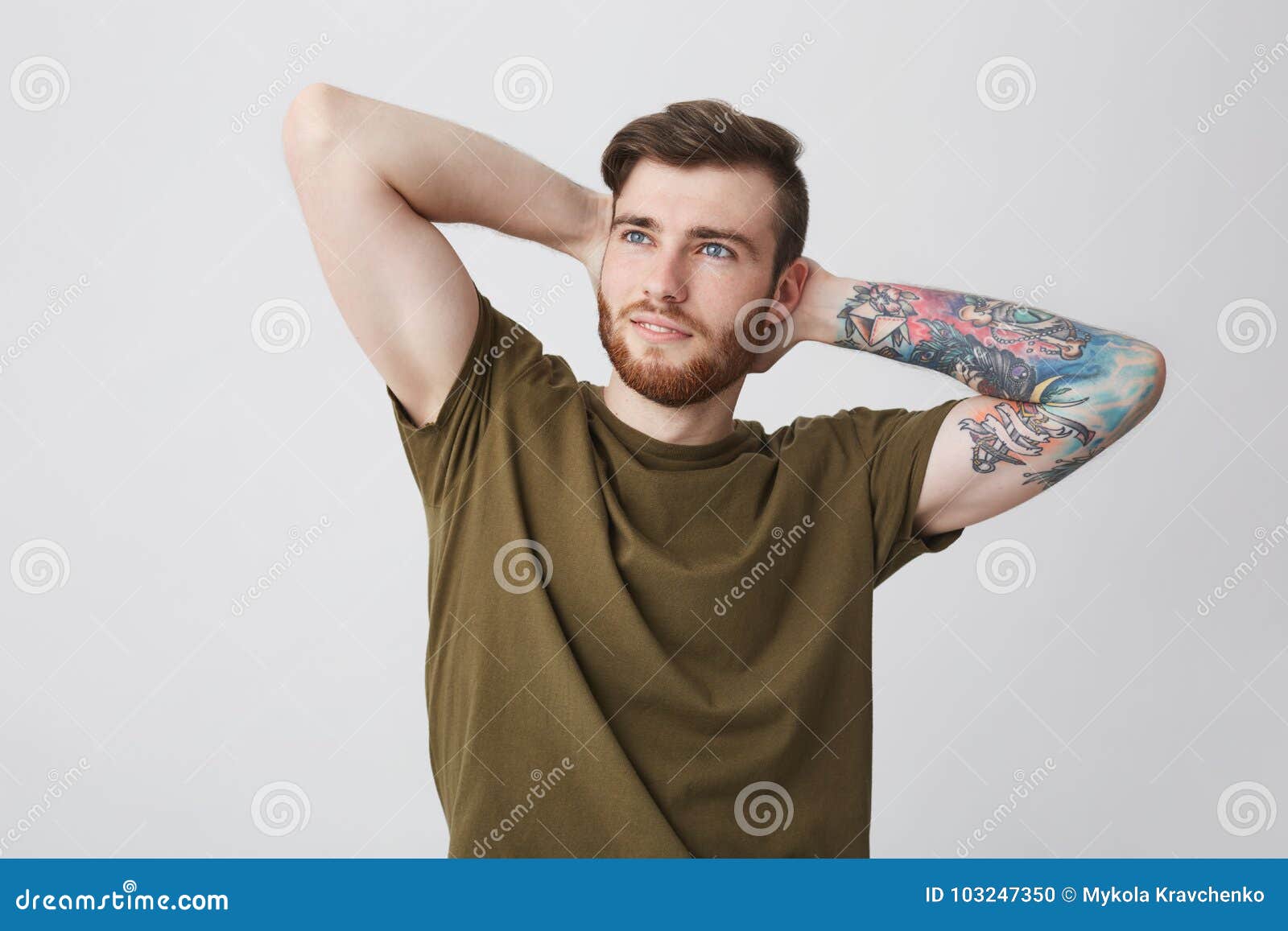 Portrait of Handsome Bearded Caucasian Man with Tattoo on Arm and Stylish Hairstyle Holding Hands Behind Head, Looking Stock Photo - Image of daylight, body: 103247350 Portrait of Handsome Bearded Caucasian Man with Tattoo on Arm and Stylish Hairstyle Holding Hands Behind Head, Looking Stock Photo - Image of daylight, body: 103247350