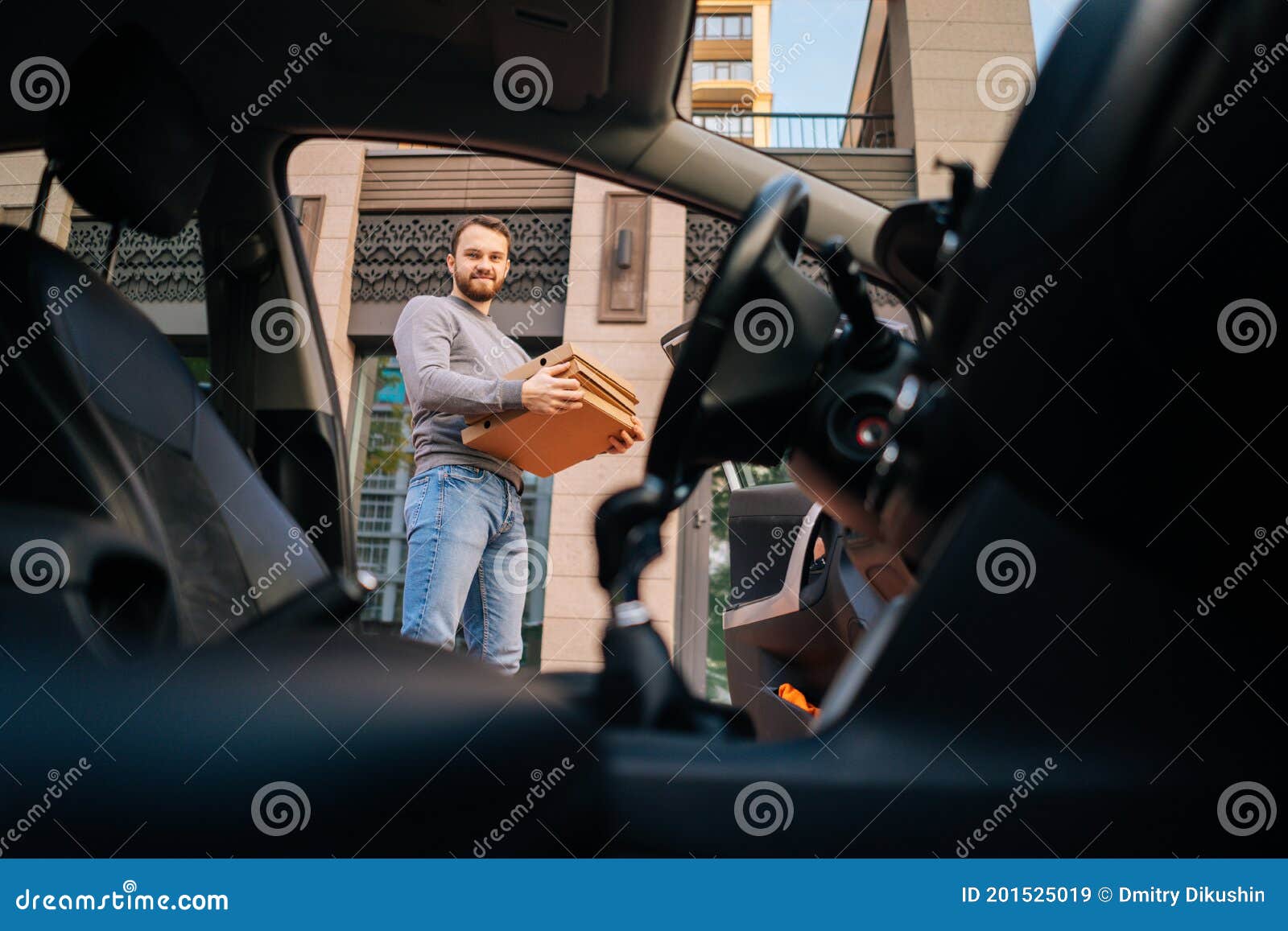 Portrait Of Handsome Caucasian Delivery Man Standing At City Street And Holding Boxes With Hot