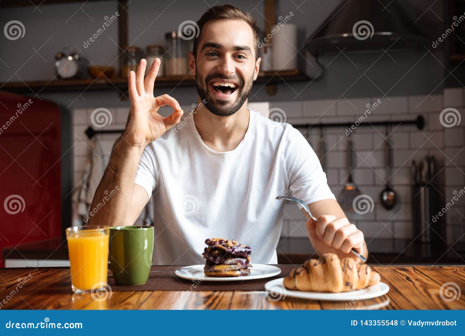 Portrait Of Handsome Man 30s Eating While Having Breakfast In Stylish