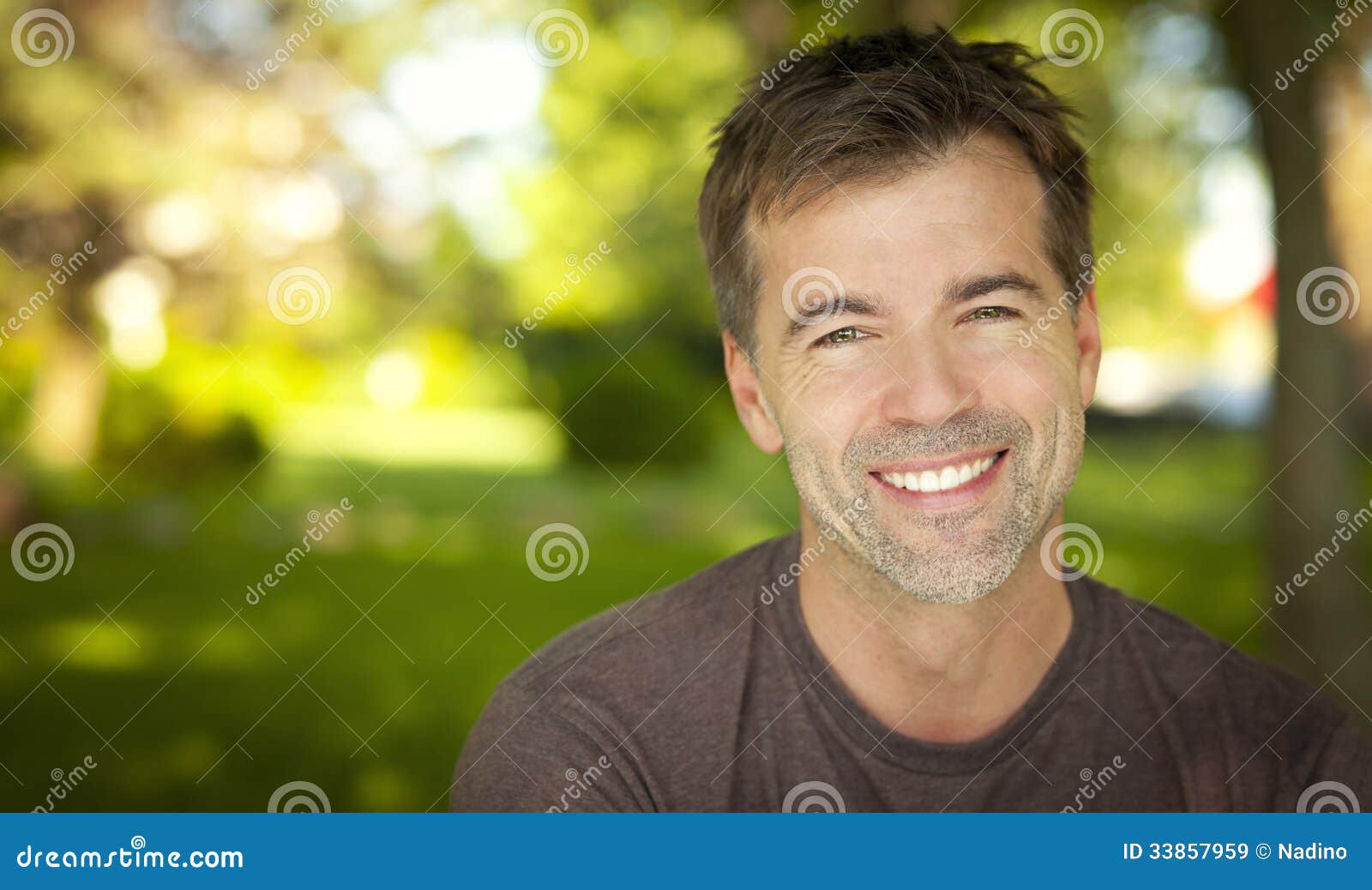 portrait of a handsome man smiling at the camera