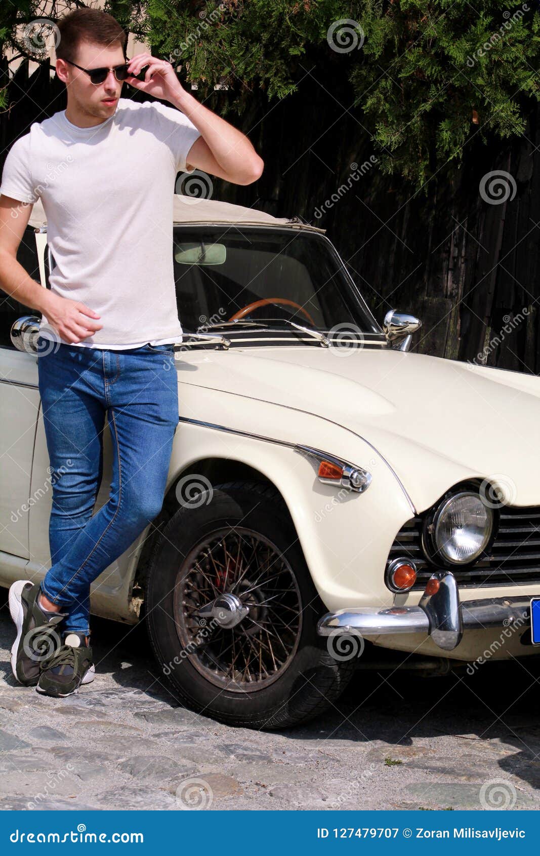 African man wear on jeans jacket posed outdoor, standing against black car  with mobile phone at hand. 10488309 Stock Photo at Vecteezy