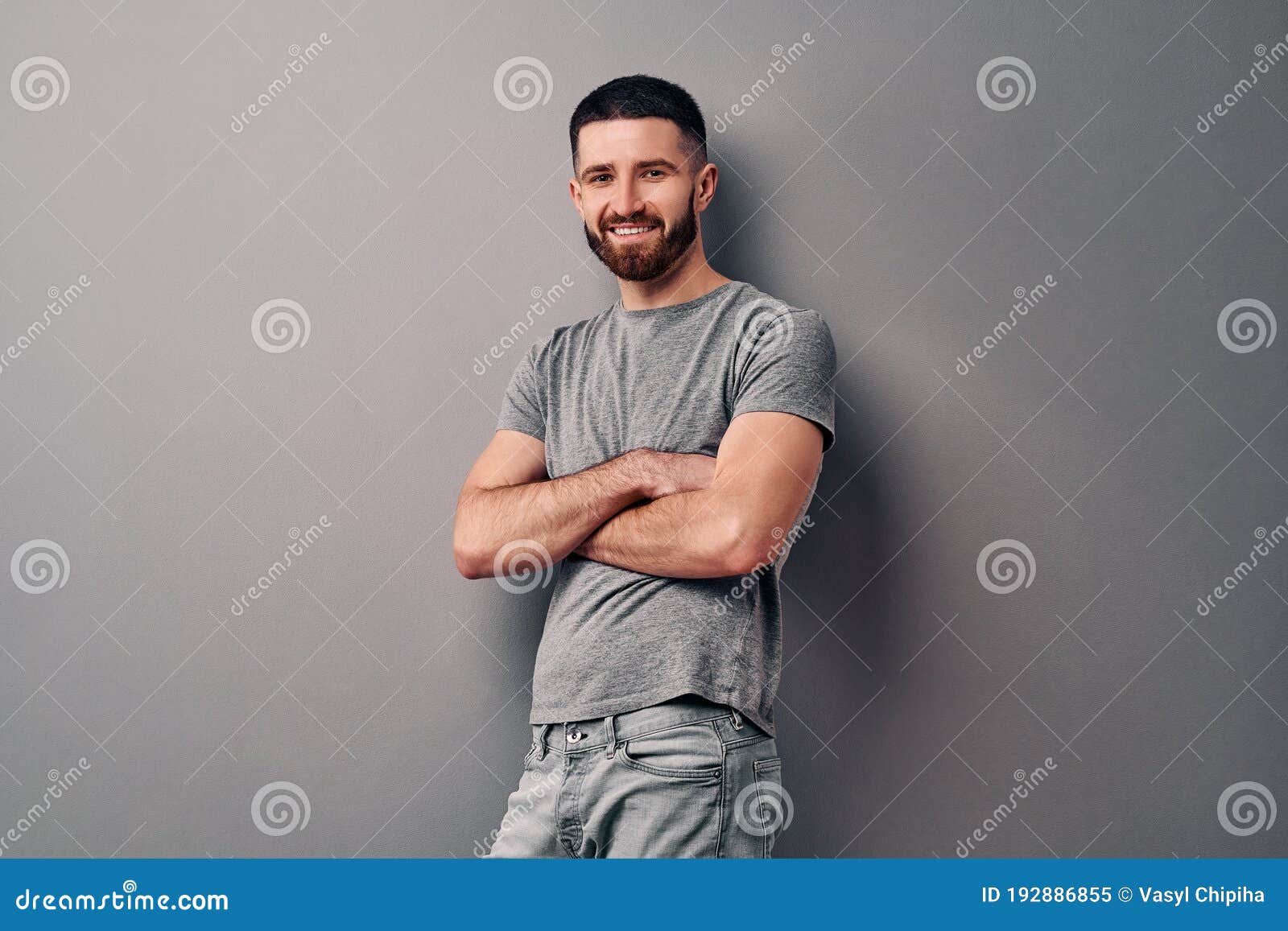 Portrait of a Handsome Young Man Who is Standing Leaning on a Gray Wall ...