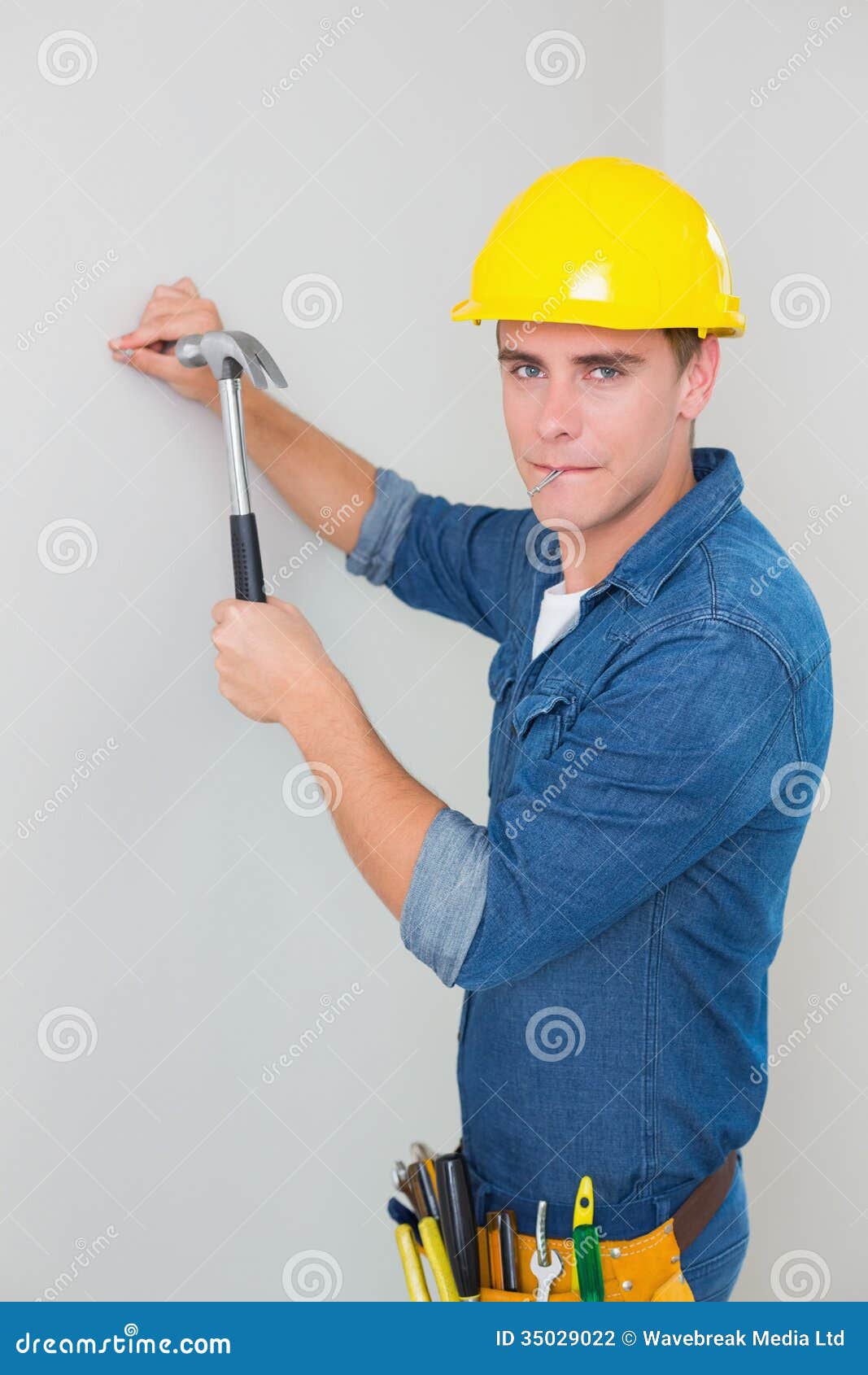 Portrait of Handyman Hammering Nail in Wall Stock Photo Image of working, years 35029022