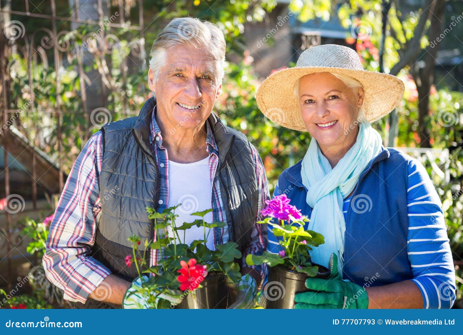 Portrait of Happy Couple Holding Potted Plants at Garden Stock Image ...