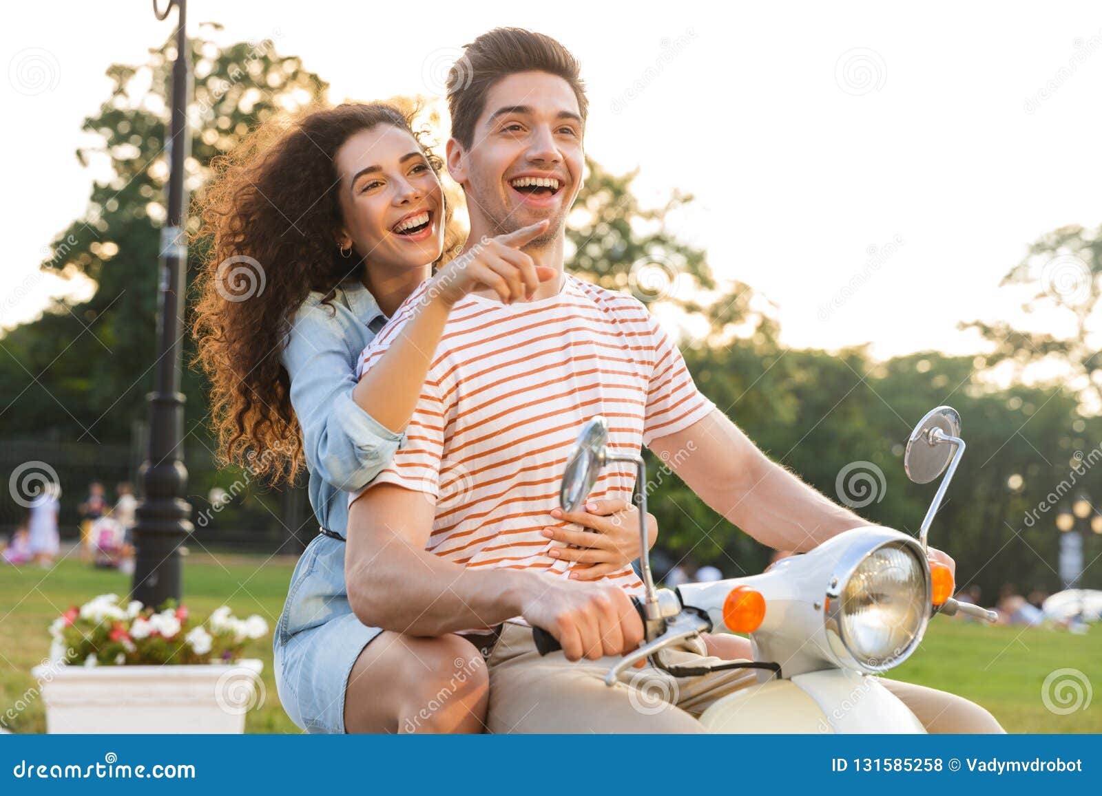 Portrait of Man and Woman Riding on Motorbike Together through City