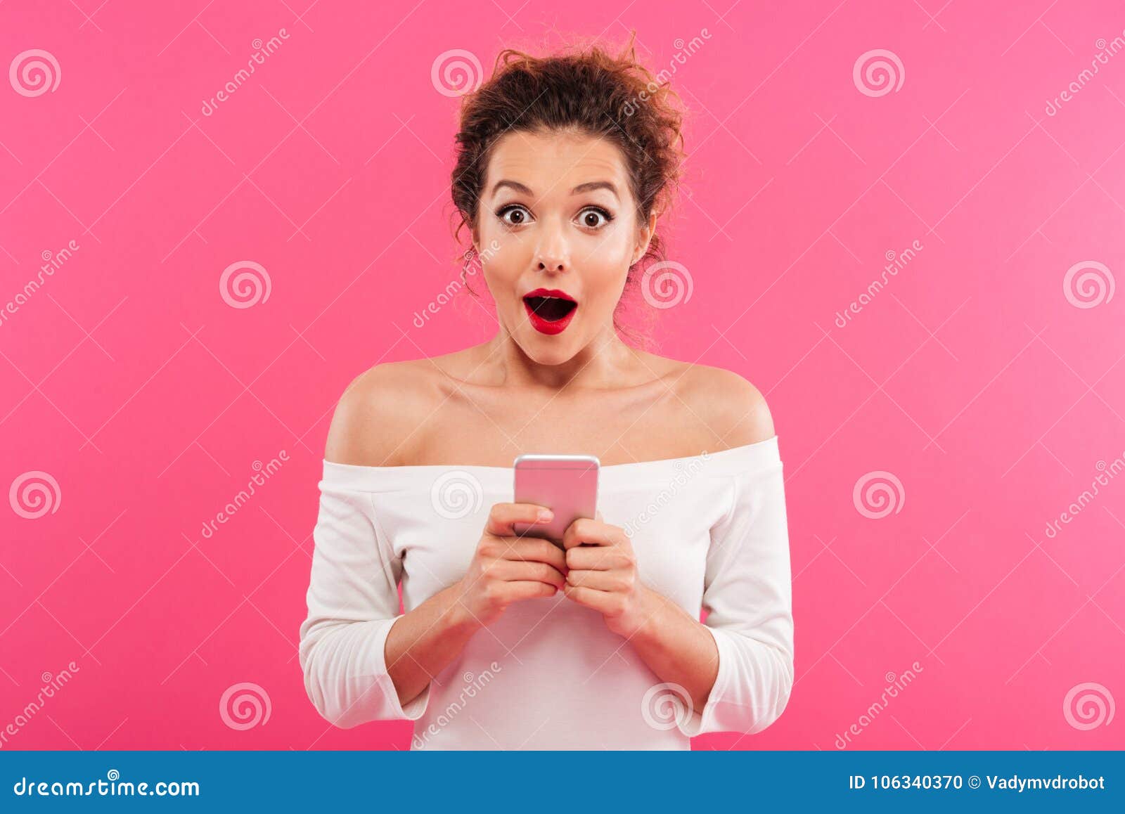 portrait of a happy excited girl holding mobile phone