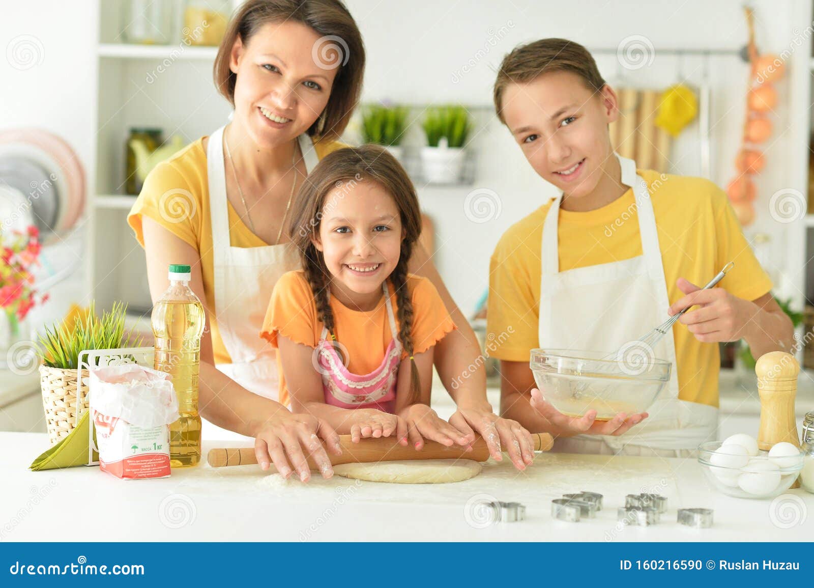 Portrait of Happy Family Baking Together in the Kitchen Stock Photo