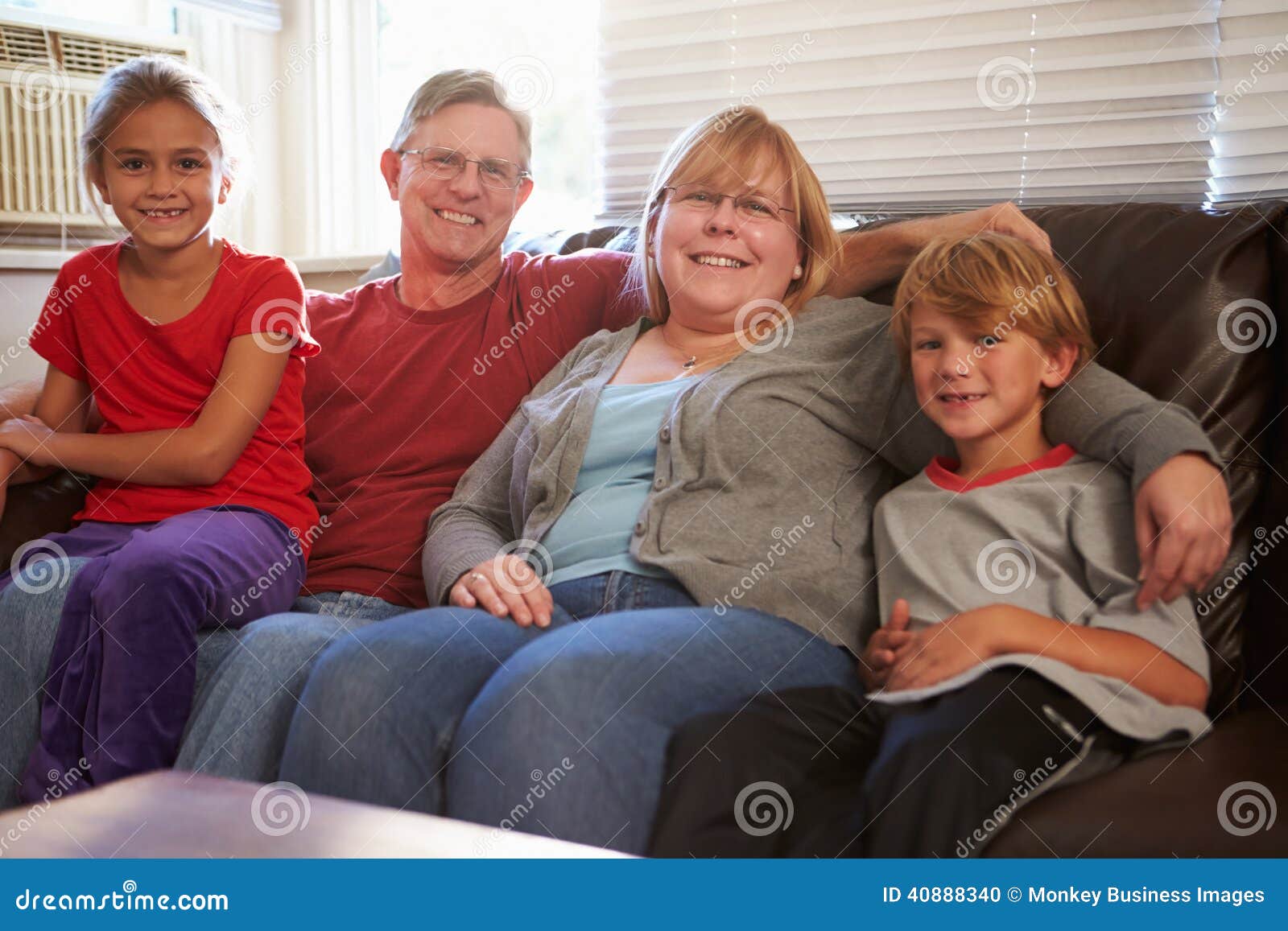 Portrait Of A Happy Together On The Portrait Of Happy Family Sitting On Sofa Together Stock