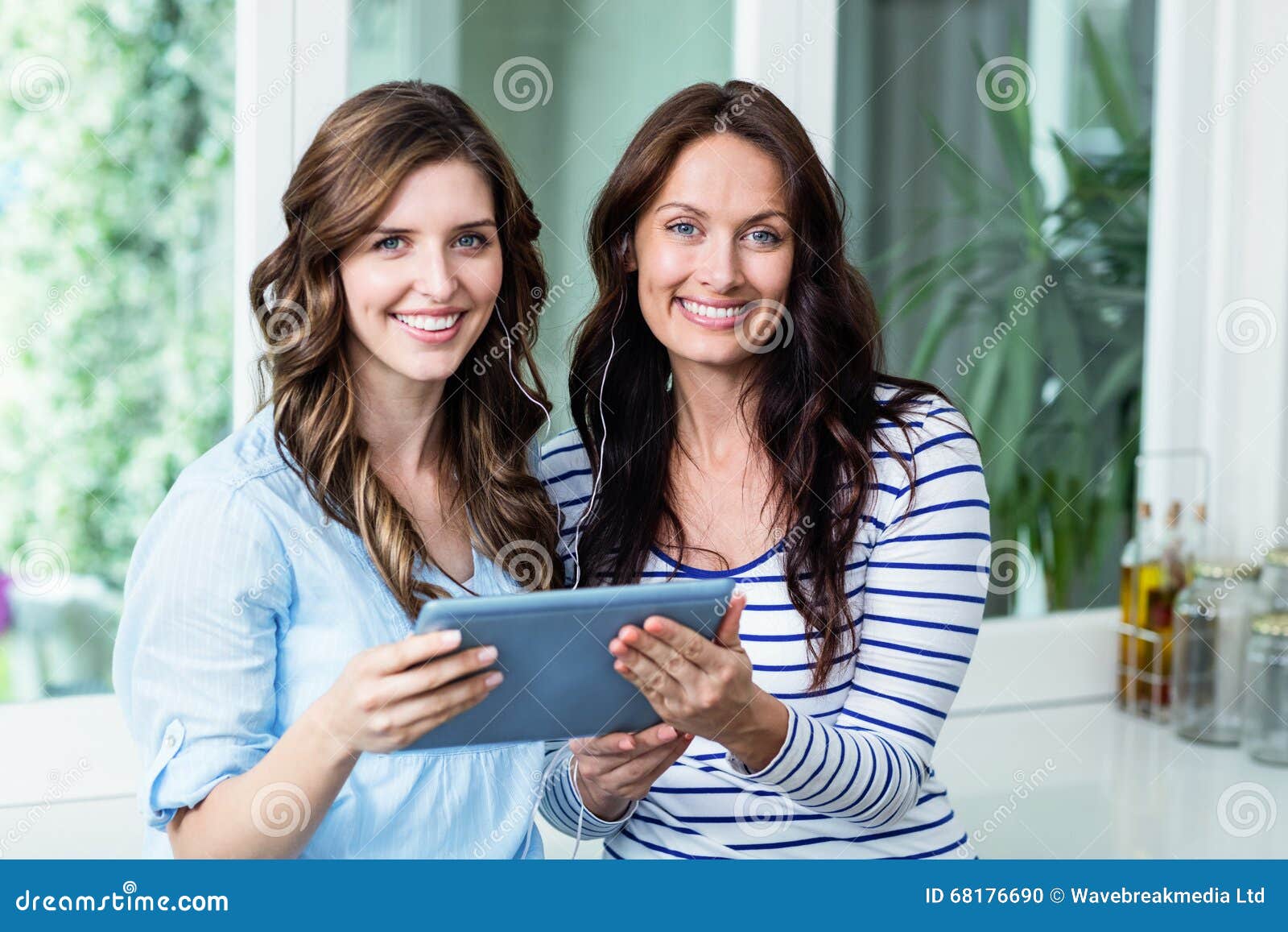 Portrait of Happy Friends Watching Video on Digital Tablet Stock Photo ...