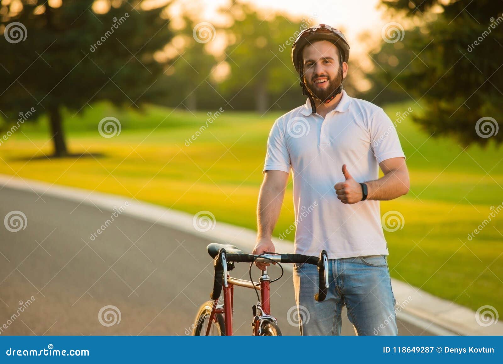 Portrait of Happy Handsome Guy with Bicycle. Stock Image - Portrait Happy HanDsome Guy Bicycle Portrait Happy HanDsome Guy Bicycle Cute Young Smiling Cyclist Giving Thumb Up 118649287