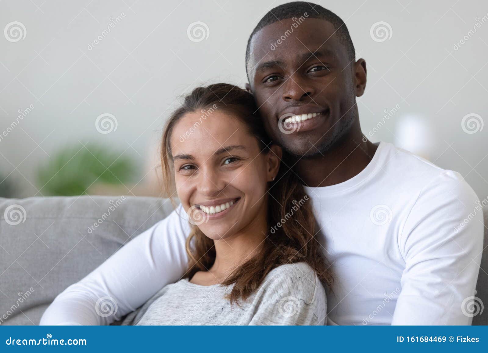 https://thumbs.dreamstime.com/z/portrait-happy-international-couple-relaxing-couch-portrait-happy-international-young-couple-hug-look-camera-relaxing-161684469.jpg
