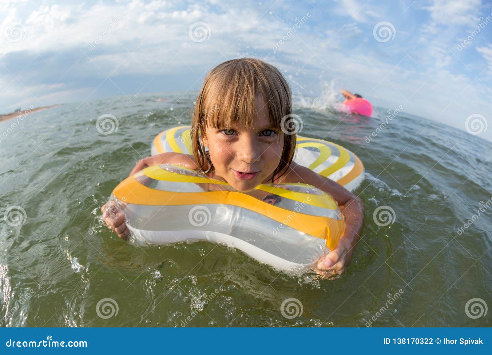 Portrait, Happy Little Girl Swims in the Sea on an Inflatable Circle ...