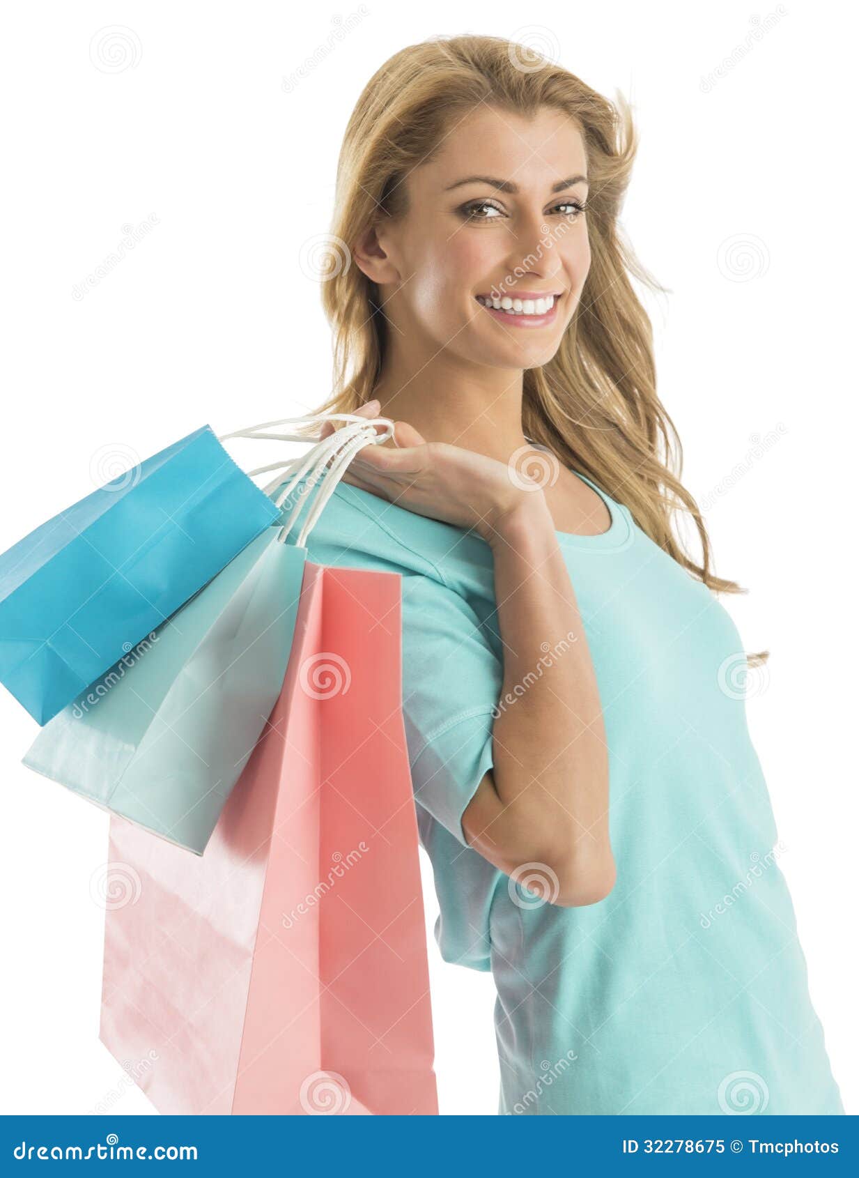 portrait of happy shopaholic woman carrying shopping bags