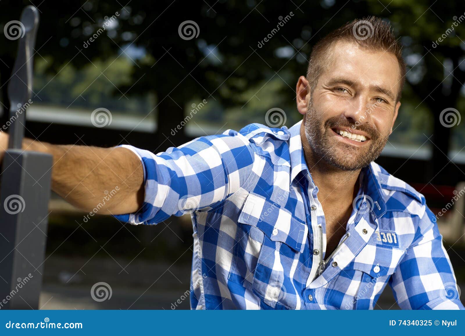 portrait of happy stubbly casual man outdoor