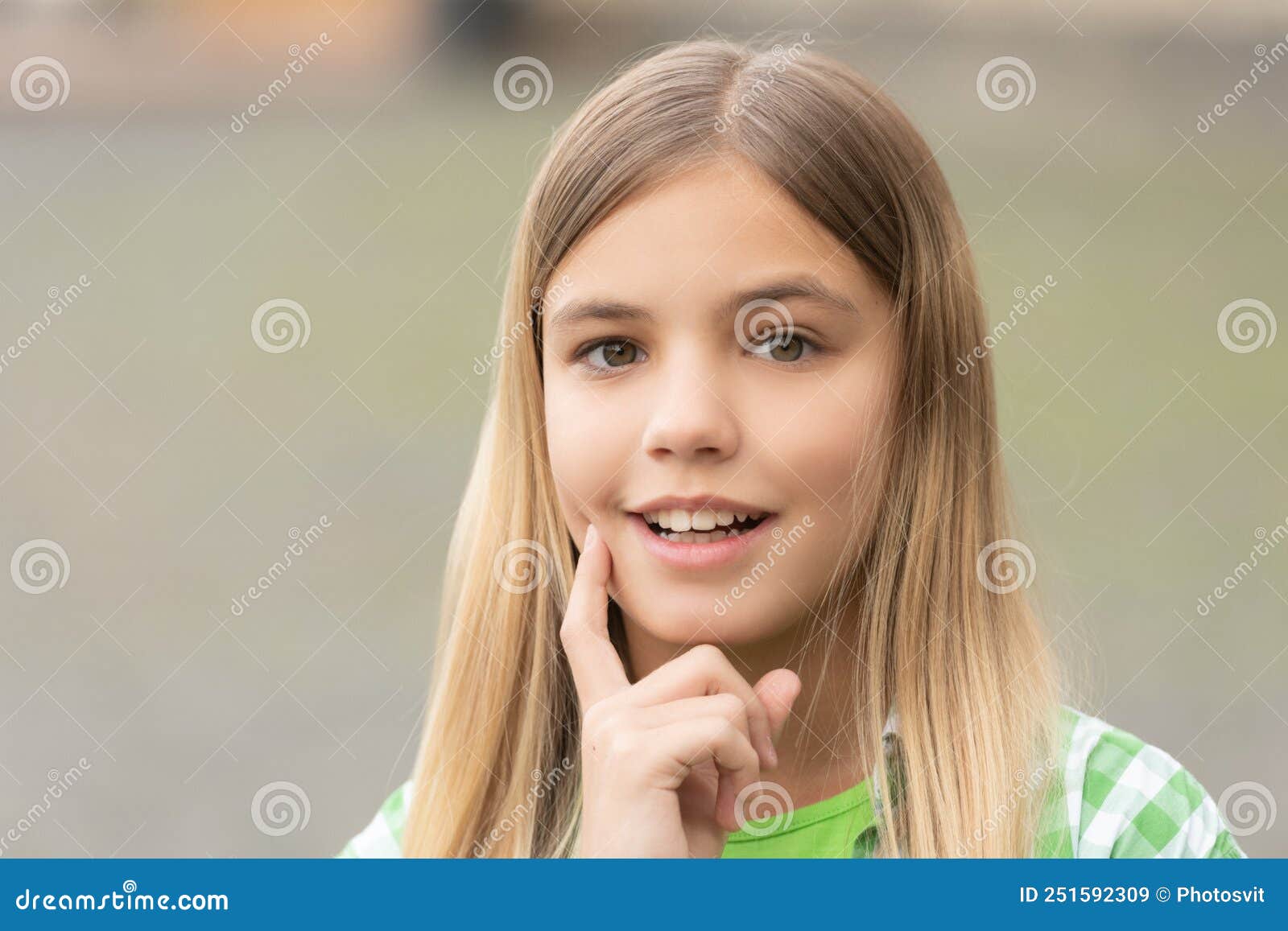 Portrait Of Happy Teenage Girl Smiling With Finger On Cheek Blurry Outdoors Stock Image Image