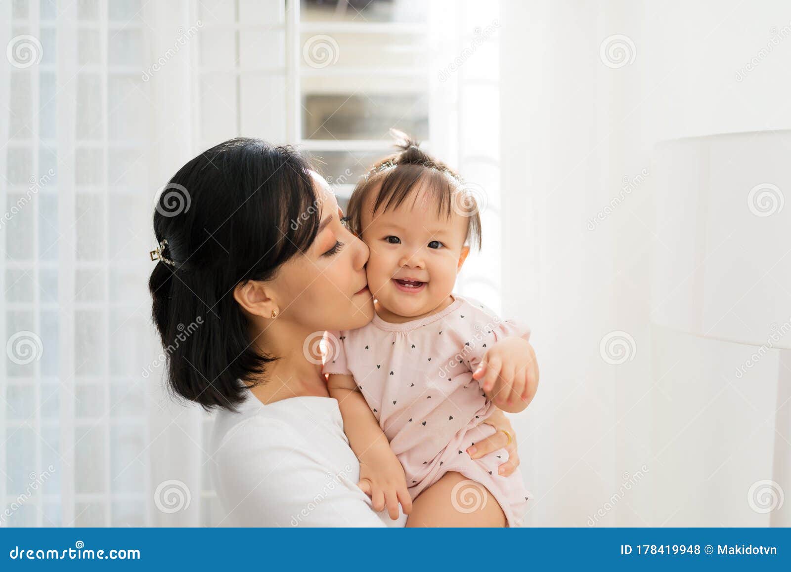 Portrait of Happy Vietnamese Mother Hugging with Her Cute Little ...