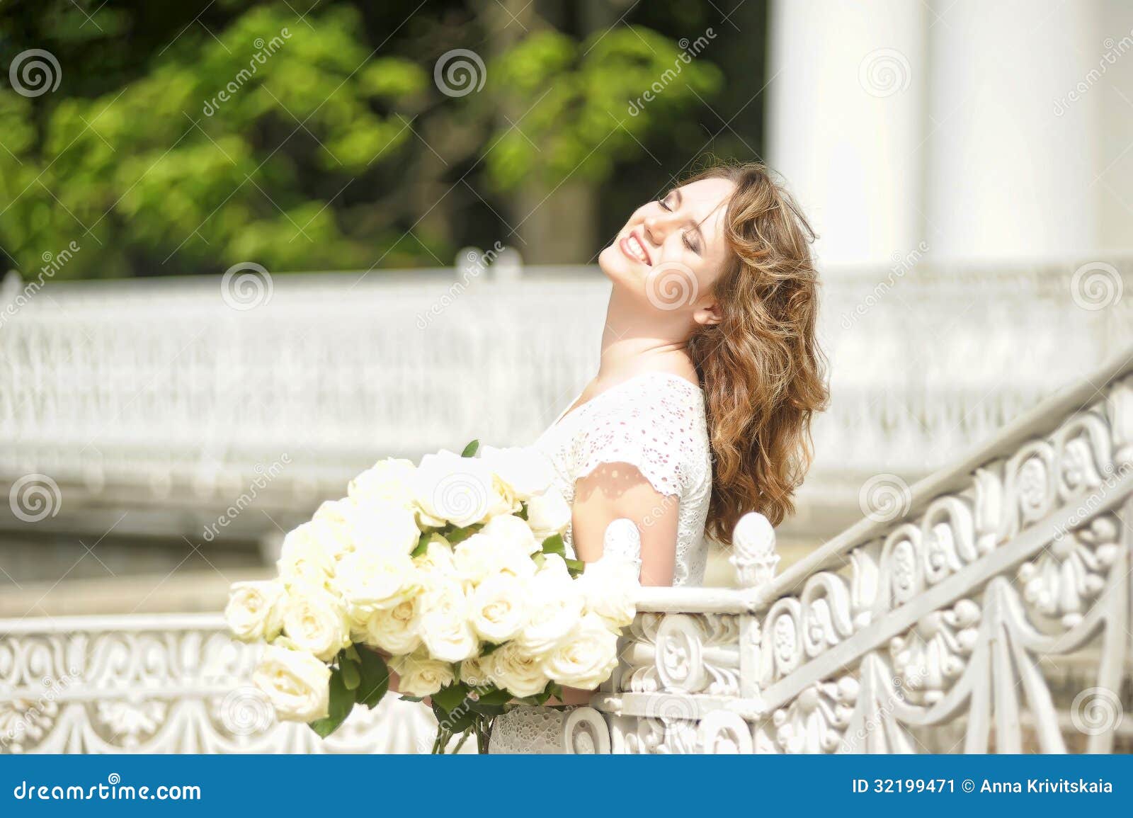 Portrait of happy woman with roses in hands