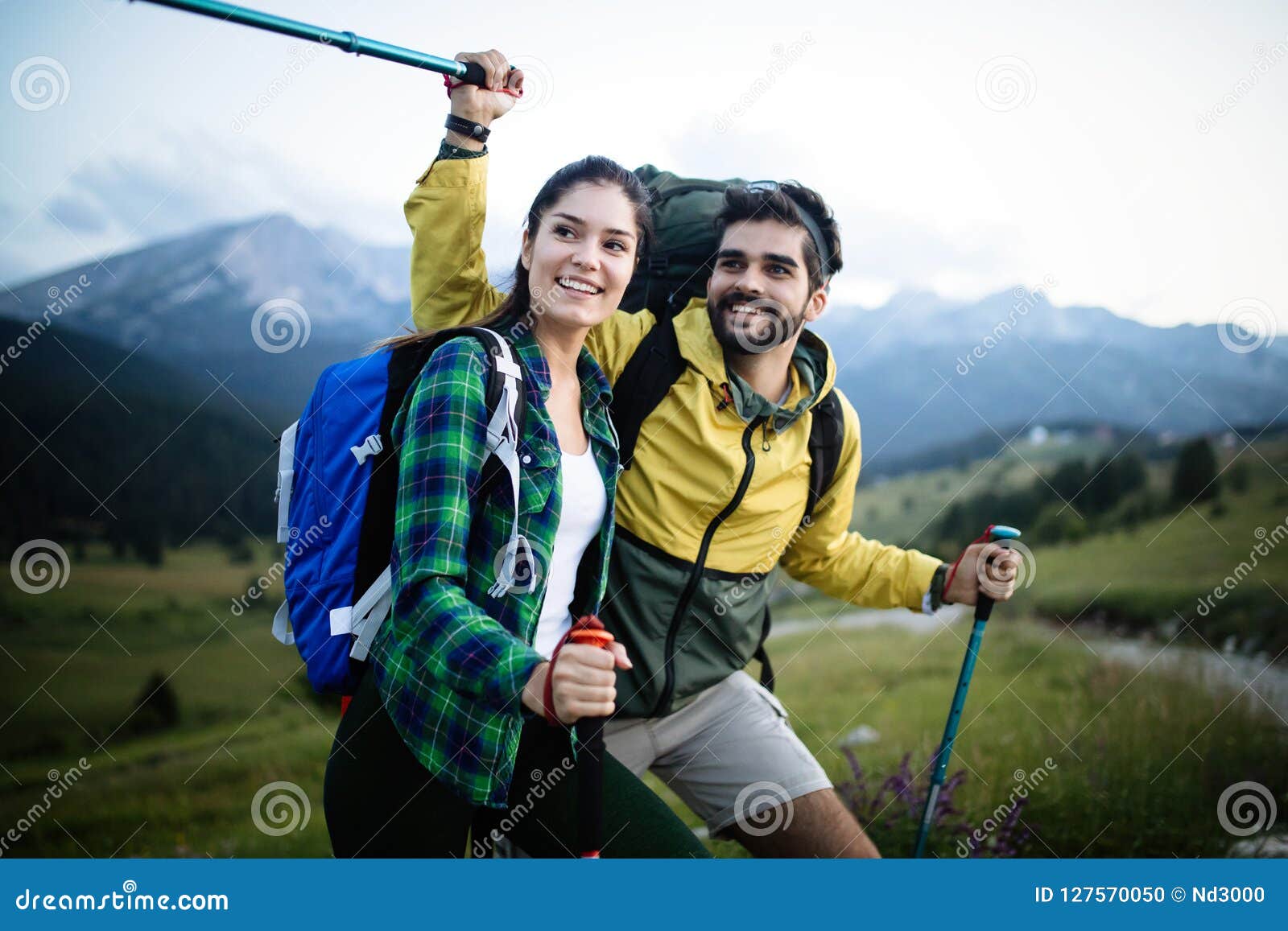 Portrait Of Happy Young Couple Having Fun On Their Hiking Trip Stock
