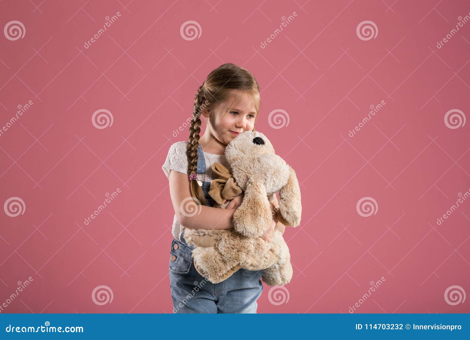 Happy Young Girl Hugging Stuffed Toy Stock Photo - Image of dungarees ...