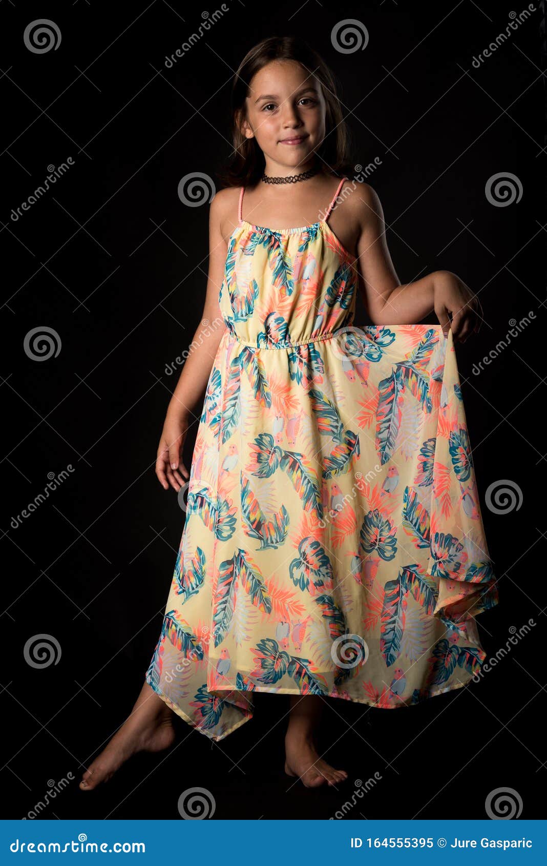 Portrait of Happy Young Little Girl Holding Long Colourful Dress Stock ...