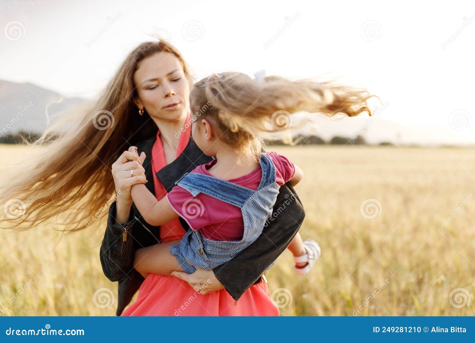 Portrait Of A Happy Young Mother And Her Lovely Daughter Playingspinning And Laughing In A 