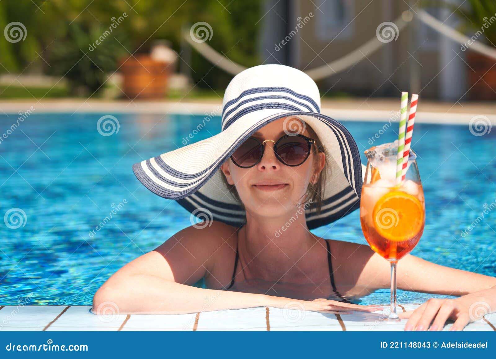 Portrait of Happy Young Woman with Sunglasses and Straw Hat Smiling in ...