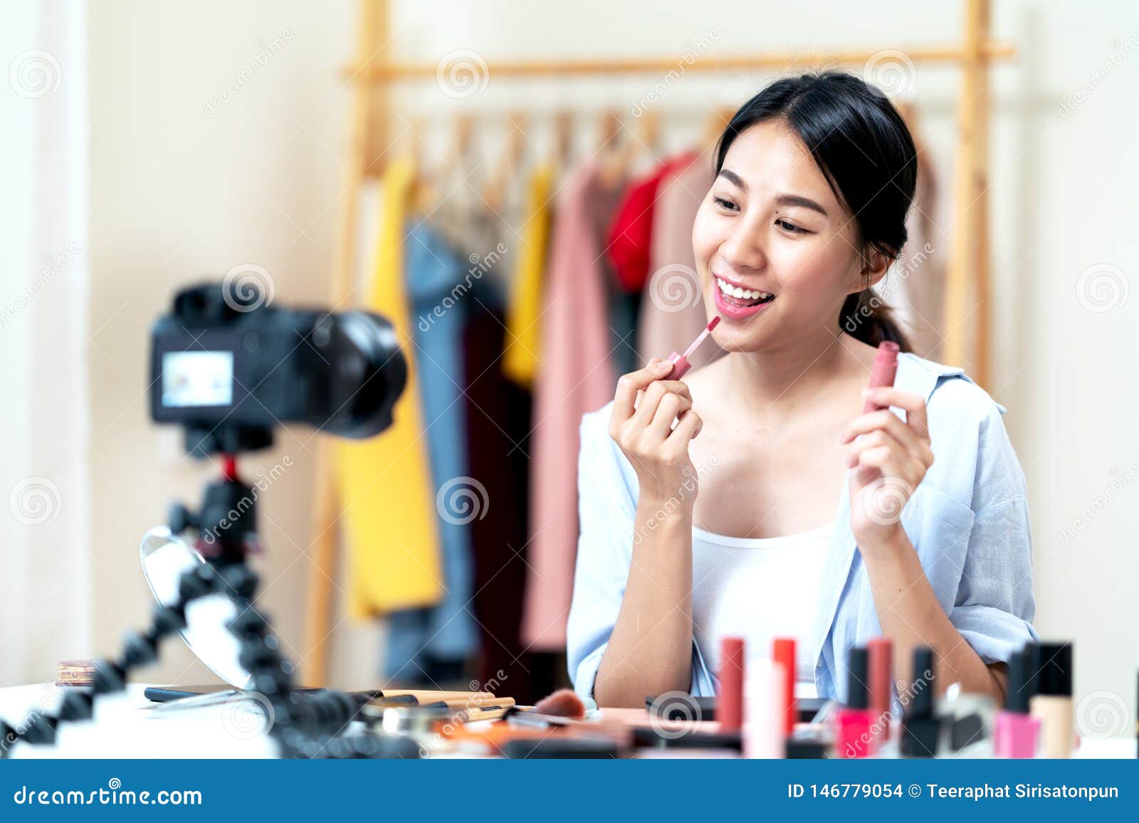 portrait or headshot of attractive young asian influencer, beauty blogger, content creator or vlogger girl review make up looking