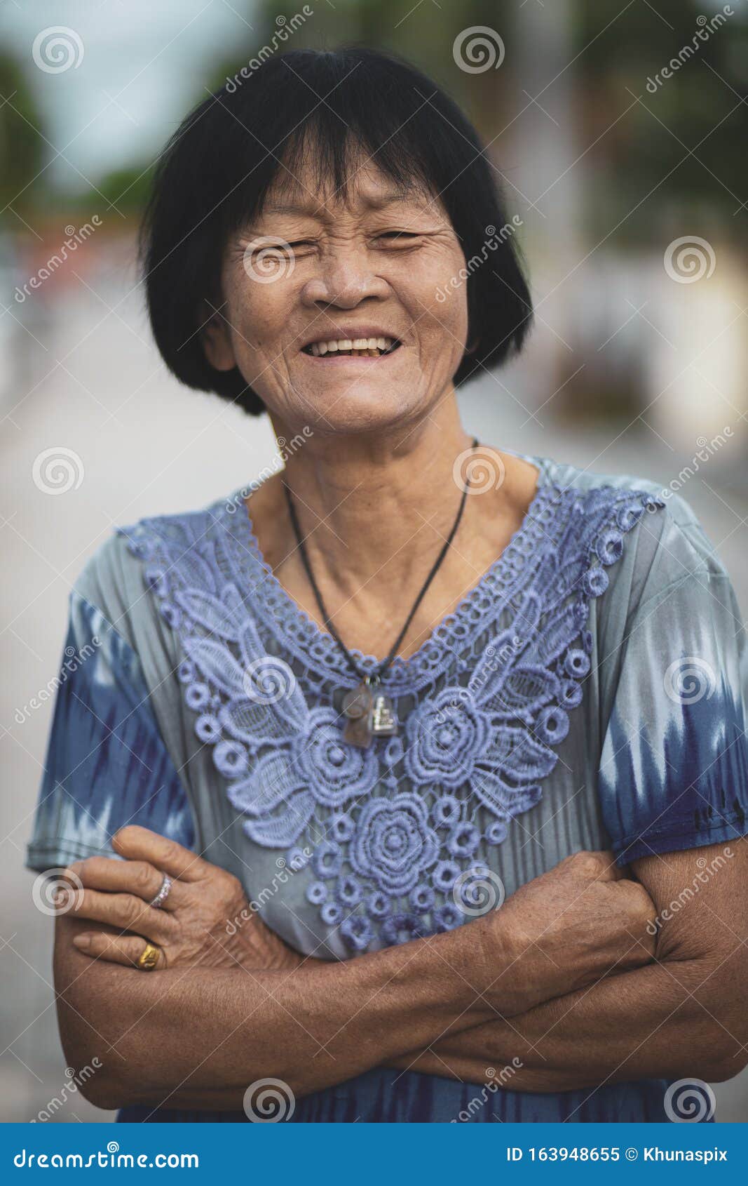 portrait headshot of old asian woman toothy smiling face